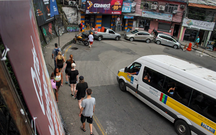 Tourists walking on a narrow street in a favela market, Rio de Janeiro.