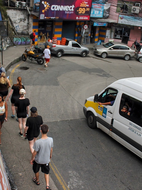Tourists walking on a narrow street in a favela market, Rio de Janeiro.