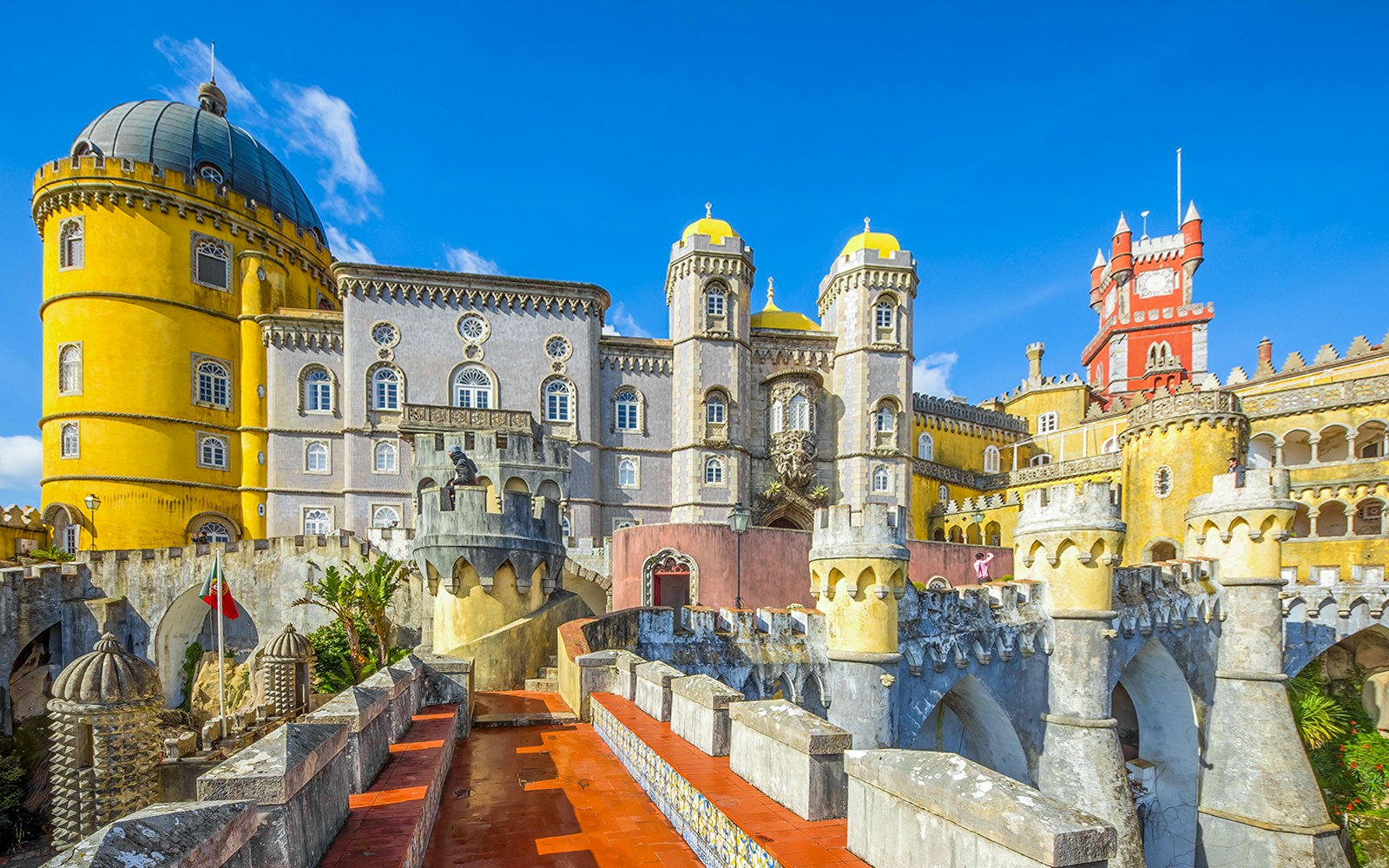 Pena Palace pathway with view of colorful castle towers in Sintra, Portugal.