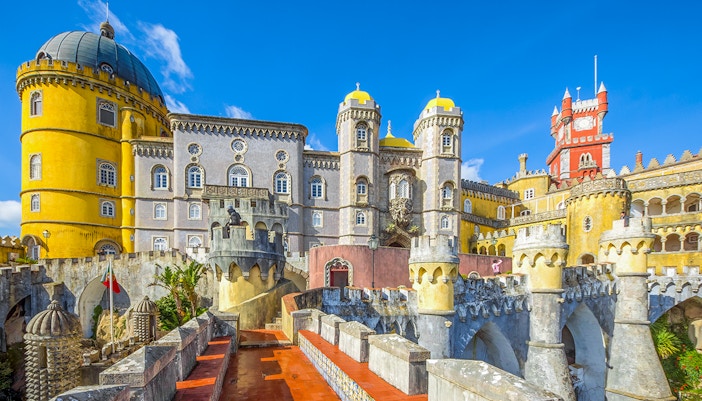 Pena Palace pathway with view of colorful castle in Sintra, Portugal.