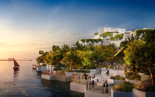 National History Museum Abu Dhabi exterior at sunset with waterfront and visitors.