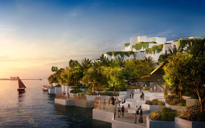 National History Museum Abu Dhabi exterior at sunset with waterfront and visitors.