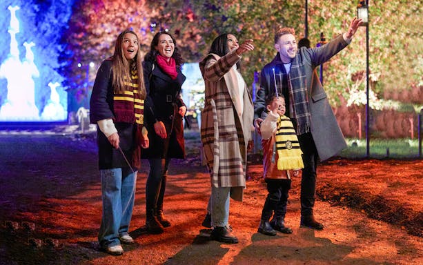 Tourists in scarves enjoying Harry Potter Forbidden Forest Experience, Singapore.