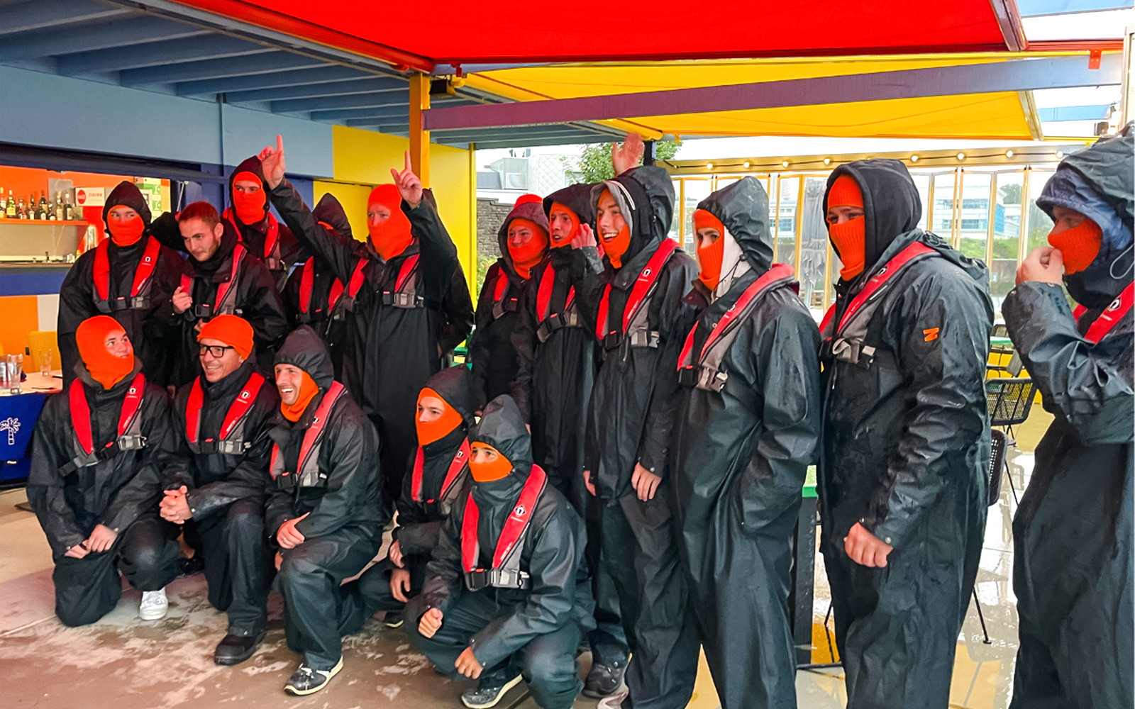 Group preparing for Rotterdam Harbour RIB speedboat tour in protective gear.