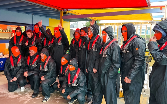 Group preparing for Rotterdam Harbour RIB speedboat tour in protective gear.
