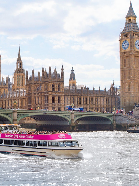 River cruise boat passing Big Ben and Houses of Parliament in London.