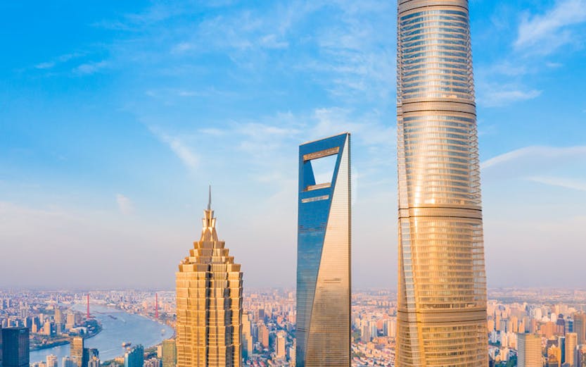 Shanghai skyline with Jin Mao Tower, Shanghai World Financial Center, and Shanghai Tower.