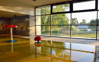 Indoor pool with mushroom fountains at Pesterzsebet Bath, Budapest.