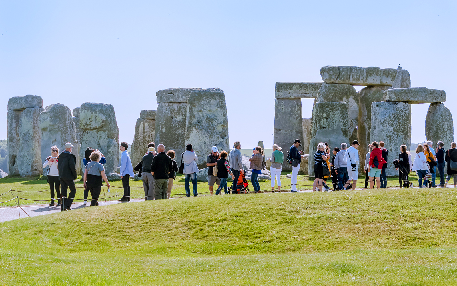 Visitors exploring Stonehenge in London, standing near ancient stone structures.