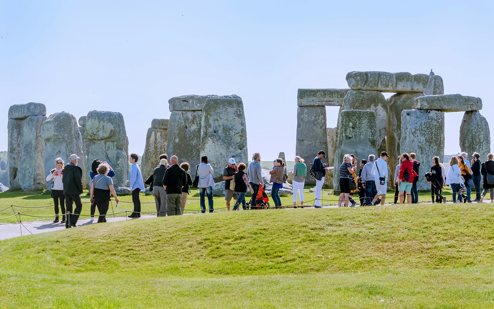 Visitors exploring Stonehenge in London, standing near ancient stone structures.