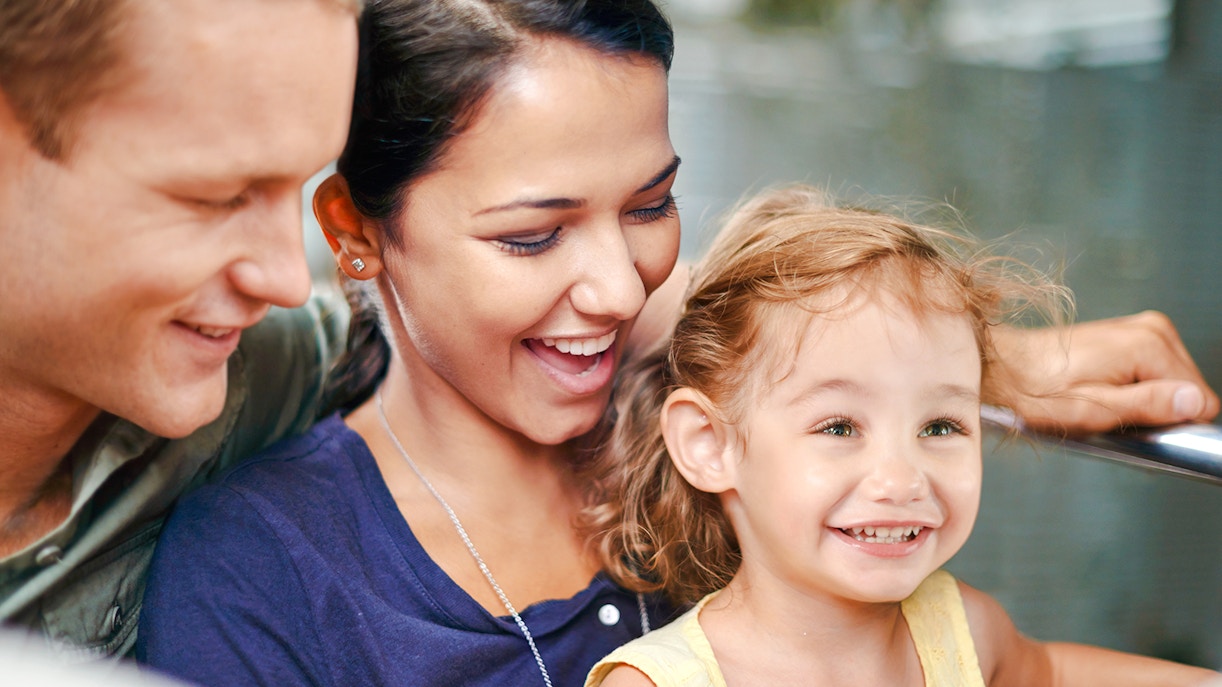Family enjoying a ride at an amusement park.