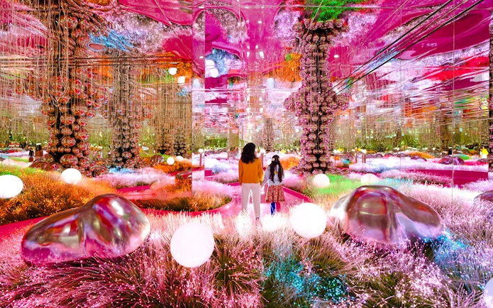 Visitors exploring a vibrant mirrored room at House of Hype, Dubai.