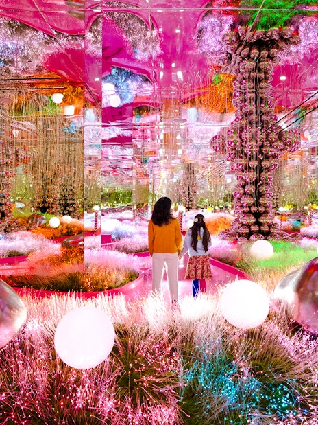Visitors exploring a vibrant mirrored room at House of Hype, Dubai.