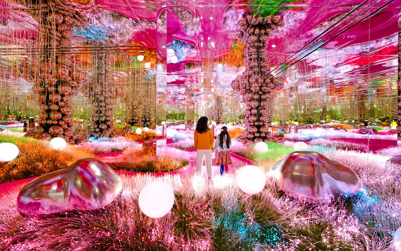 Visitors exploring a vibrant mirrored room at House of Hype, Dubai.