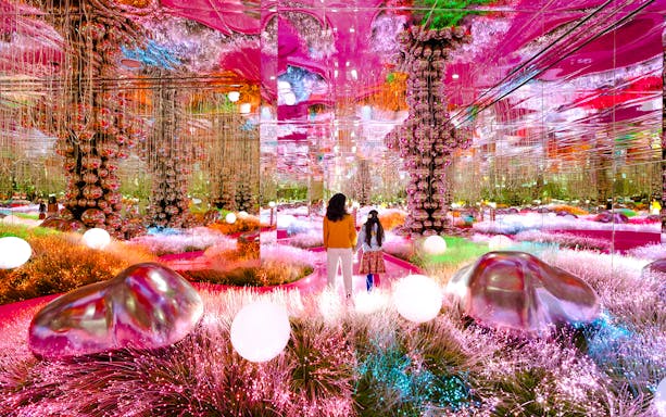 Visitors exploring a vibrant mirrored room at House of Hype, Dubai.