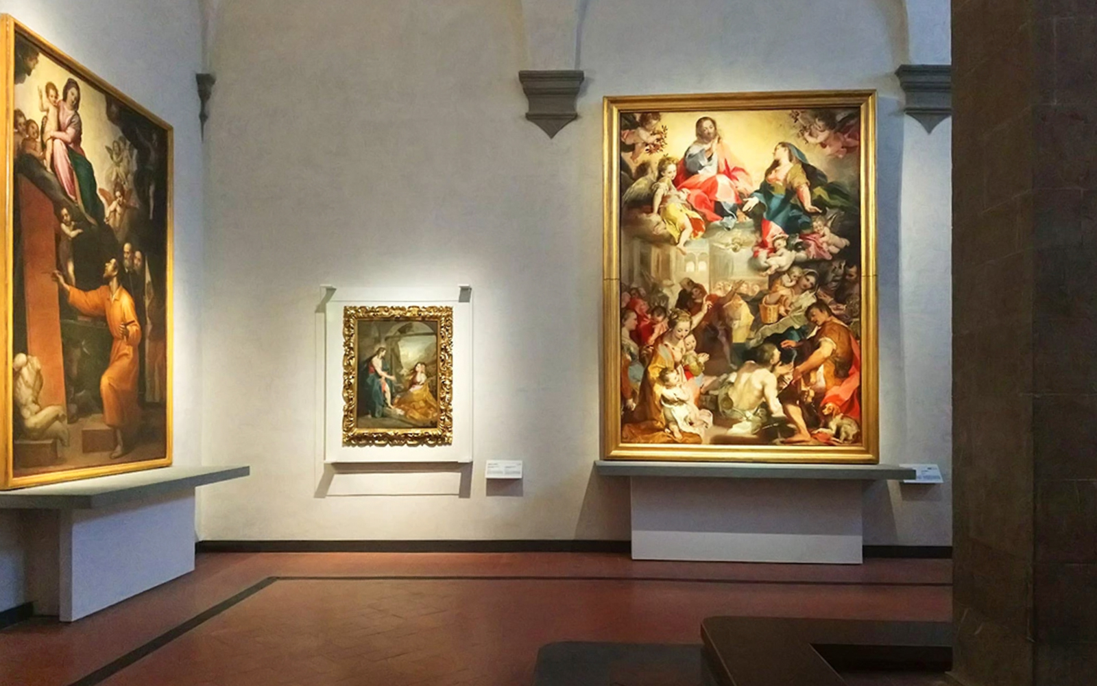 Paintings displayed in a gallery room at the Uffizi Gallery, Florence.