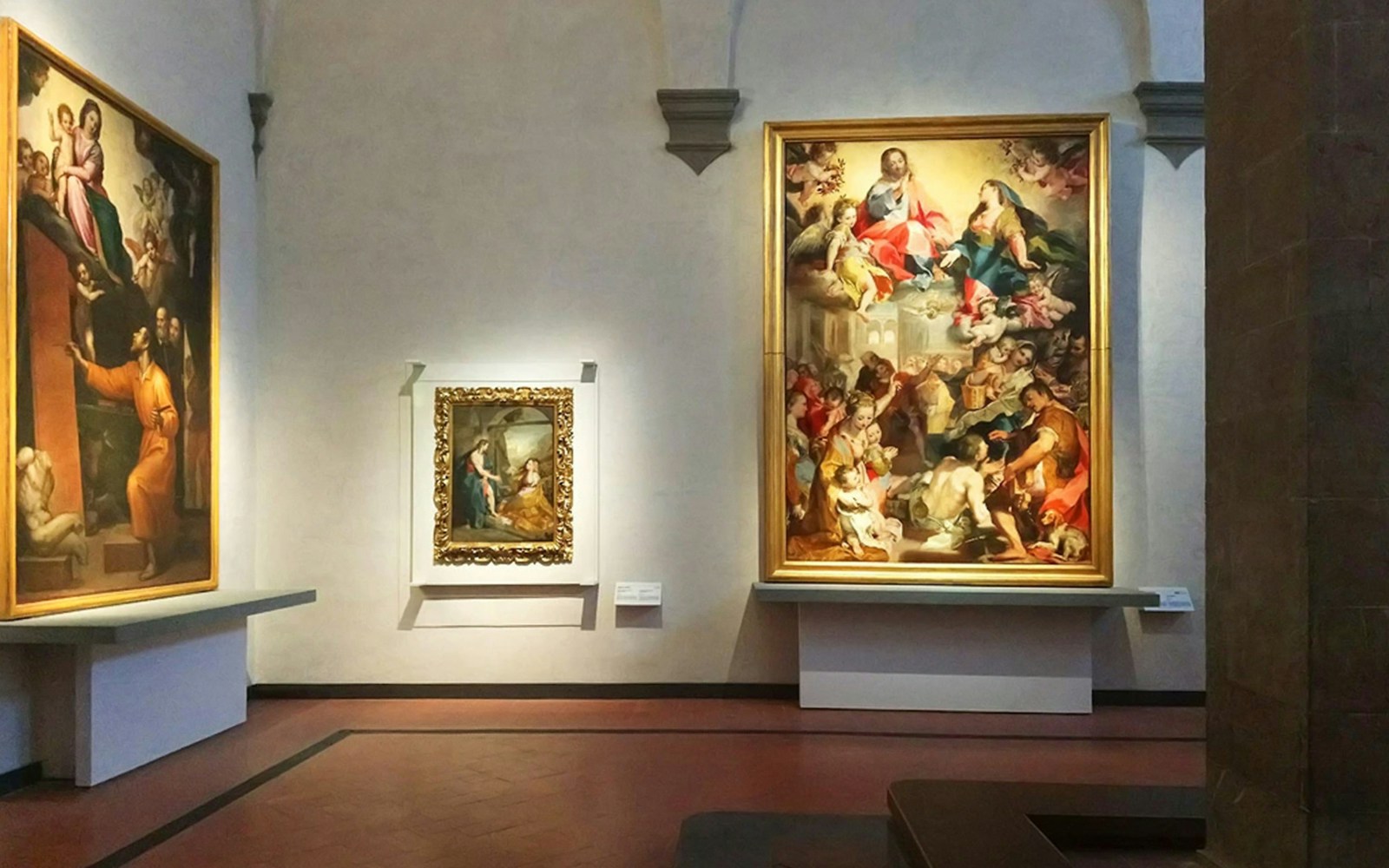 Paintings displayed in a gallery room at the Uffizi Gallery, Florence.