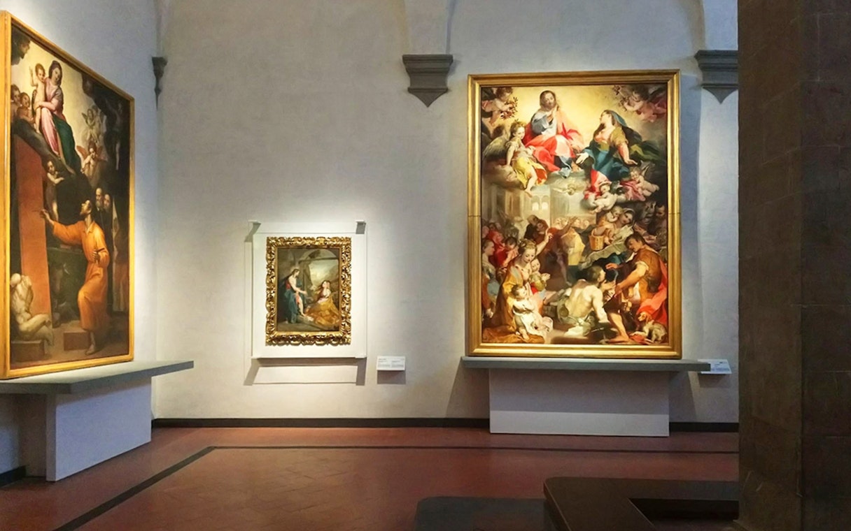 Paintings displayed in a gallery room at the Uffizi Gallery, Florence.