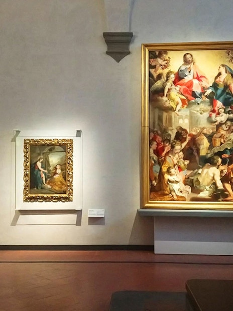 Paintings displayed in a gallery room at the Uffizi Gallery, Florence.
