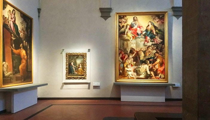 Visitors exploring artwork inside the Uffizi Gallery, Florence.