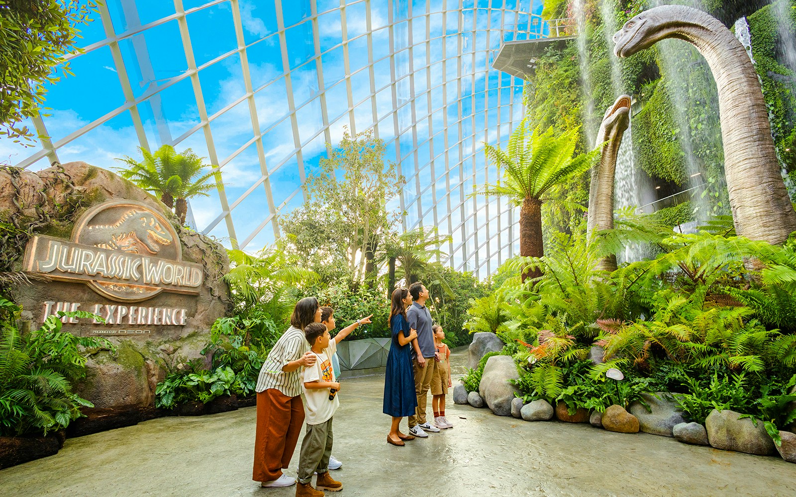Visitors exploring dinosaur exhibits at Jurassic World, Cloud Forest, Gardens by the Bay, Singapore.