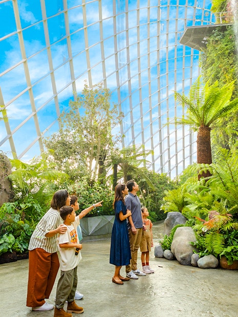 Visitors exploring dinosaur exhibits at Jurassic World, Cloud Forest, Gardens by the Bay, Singapore.