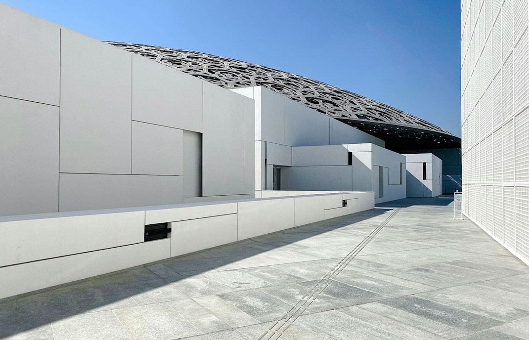 Louvre Abu Dhabi exterior with geometric architecture and dome roof.