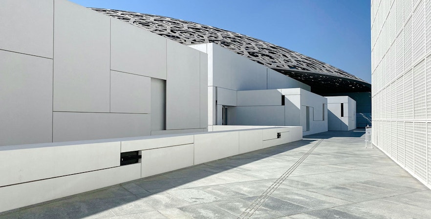Louvre Abu Dhabi exterior with geometric architecture and dome roof.