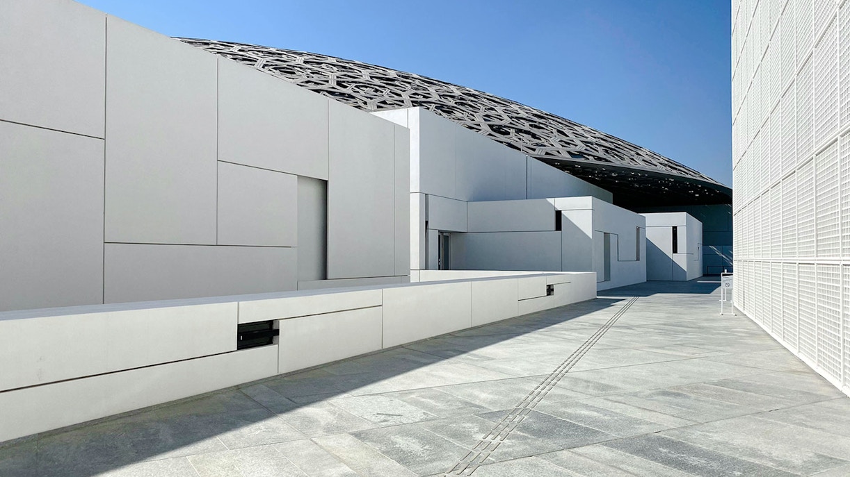 Louvre Abu Dhabi exterior with geometric architecture and dome roof.