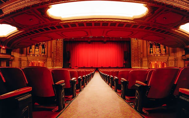 Interior view of The Chicago Theatre with red seats and ornate ceiling on The Chicago Theatre Tour Experience.