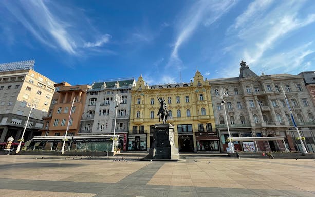Zagreb's Ban Jelačić Square with historic buildings and equestrian statue.