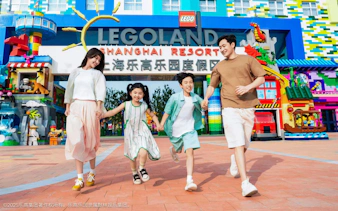 Family running at LEGOLAND Shanghai Resort entrance, China.