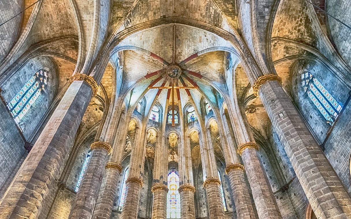 Interior view of Santa Maria del Mar's vaulted ceiling and stained glass windows.