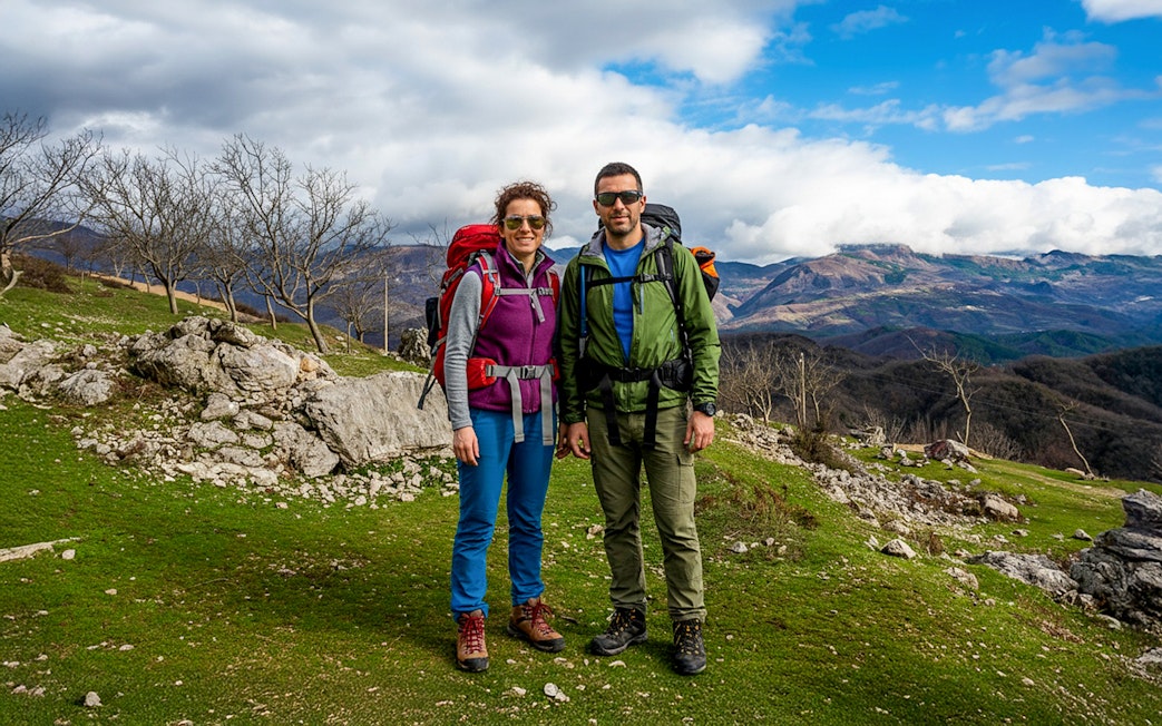 Hikers on Bovilla Lake & Gamti Mountain tour with scenic mountain backdrop.