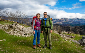 Hikers on Bovilla Lake & Gamti Mountain tour with scenic mountain backdrop.