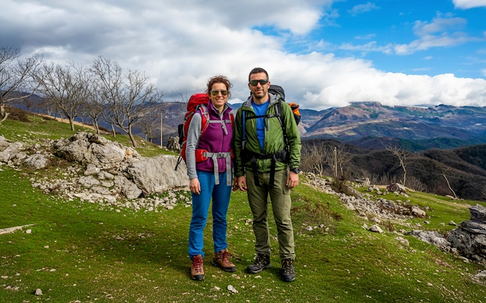 Hikers on Bovilla Lake & Gamti Mountain tour with scenic mountain backdrop.