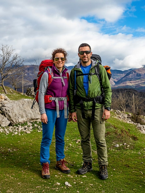 Hikers on Bovilla Lake & Gamti Mountain tour with scenic mountain backdrop.
