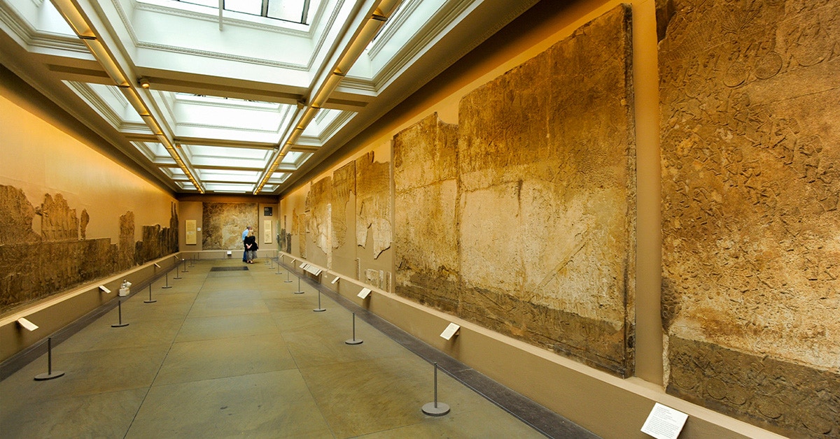 British Museum exhibition room displaying ancient wall carvings.