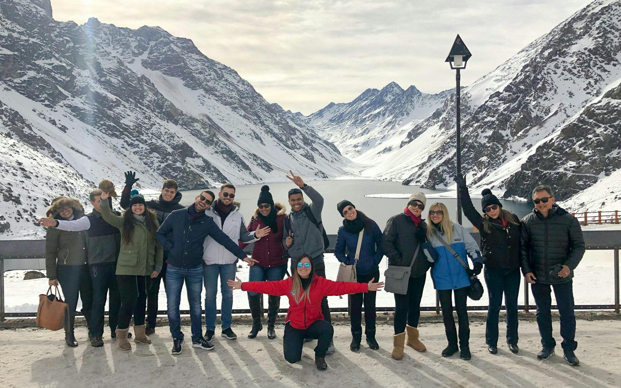 Tourists enjoying the snowy landscape at Laguna del Inca, Chile.