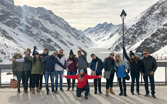 Tourists enjoying the snowy landscape at Laguna del Inca, Chile.