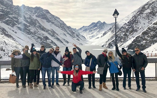 Tourists enjoying the snowy landscape at Laguna del Inca, Chile.