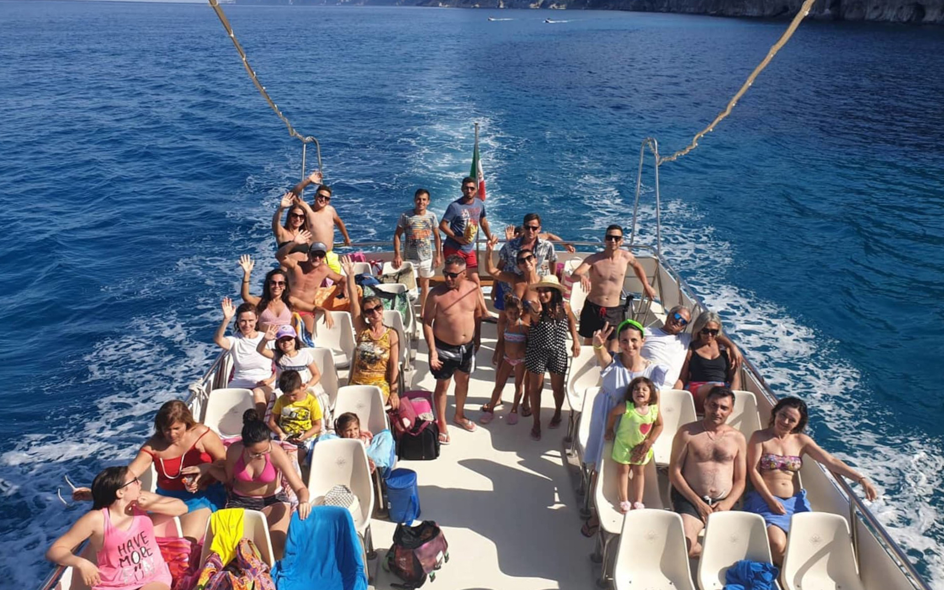 Group enjoying a boat tour at Gulf of Orosei, Italy.