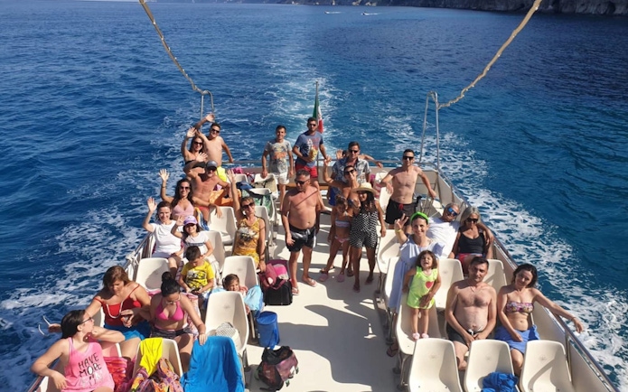 Group enjoying a boat tour at Gulf of Orosei, Italy.