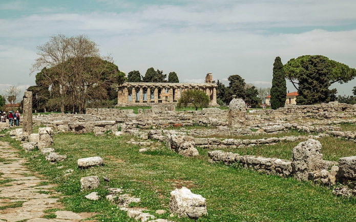 Paestum archaeological site with ancient ruins and temple in Italy.