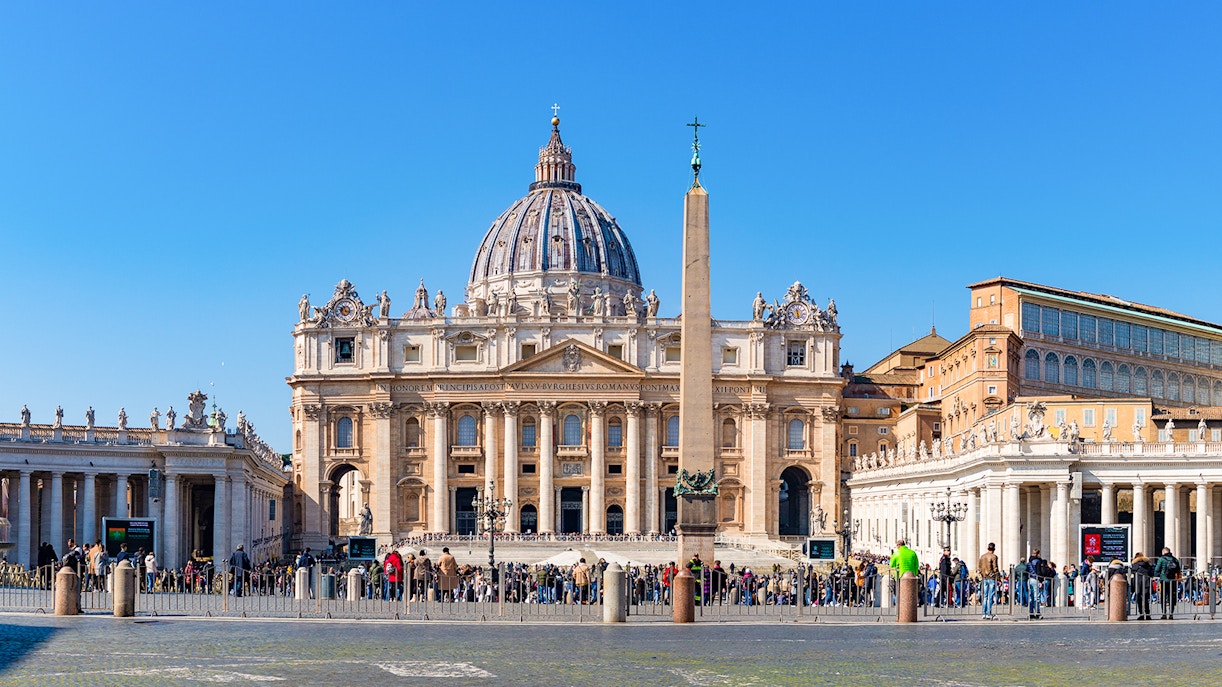 St. Peter's Basilica and Square with obelisk, Vatican City, crowded with visitors.