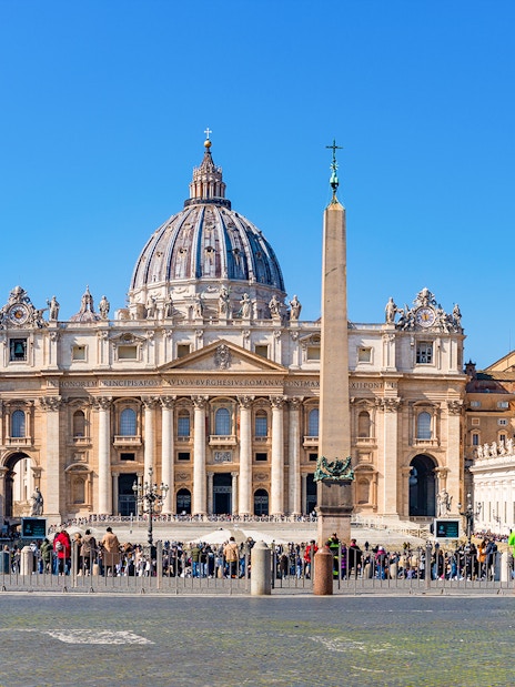 St. Peter's Basilica and Square with obelisk, Vatican City, crowded with visitors.