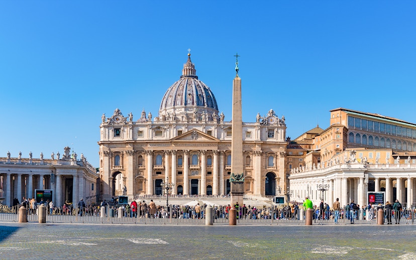 St. Peter's Basilica and Square with obelisk, Vatican City, crowded with visitors.