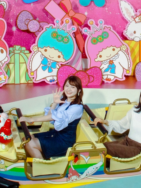 Visitors enjoying a ride with Hello Kitty at Sanrio Puroland, Japan.