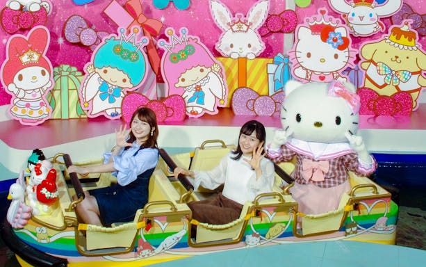 Visitors enjoying a ride with Hello Kitty at Sanrio Puroland, Japan.
