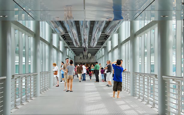 Visitors exploring the Skybridge of Petronas Twin Towers in Kuala Lumpur.